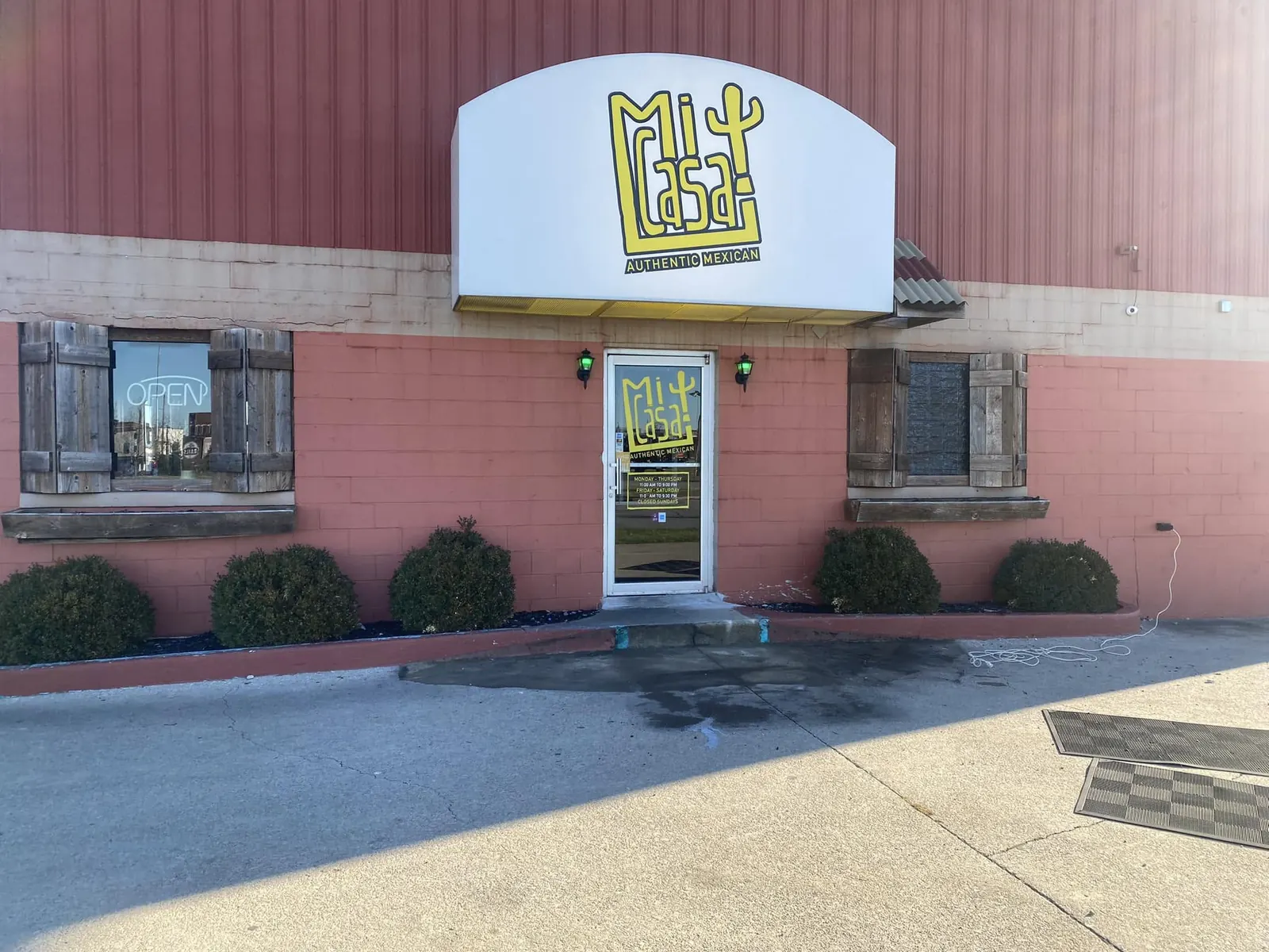 The Mi Casa storefront with its yellow logo sign above the door